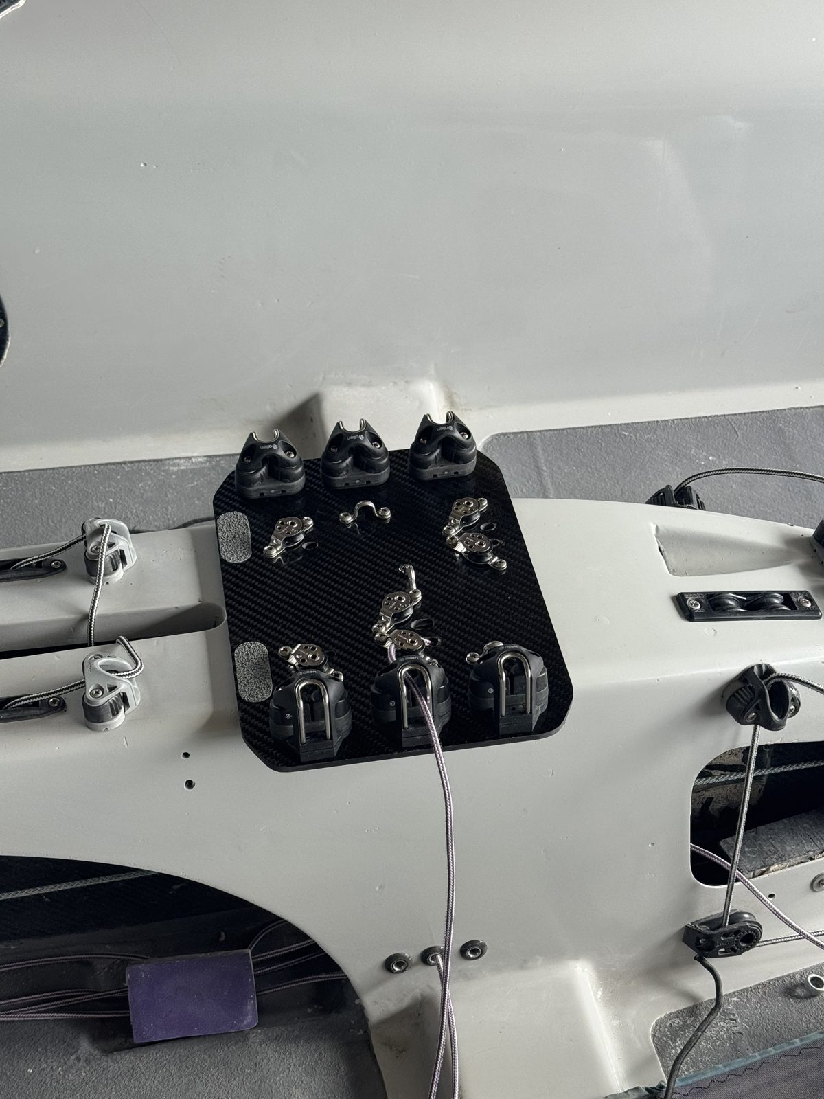 Close-up of custom carbon fittings and cleat console in a 505 cockpit